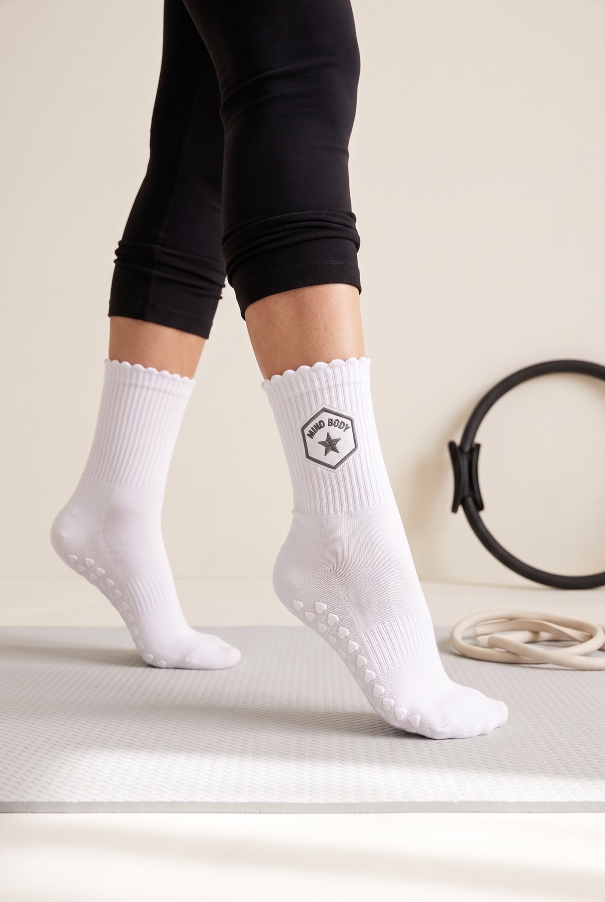 Optical White ruffle pilates grip socks, worn in a pilates studio — embroidered to order