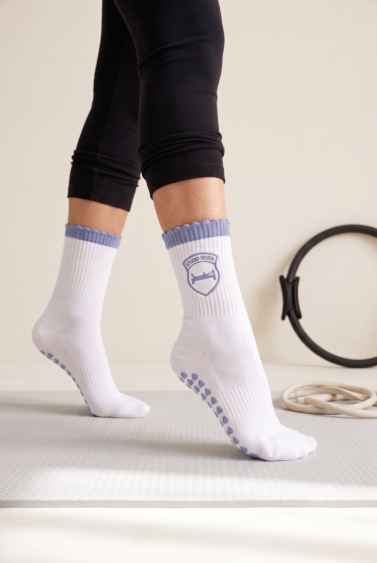 Light Blue ruffle pilates grip socks, worn in a pilates studio — embroidered to order