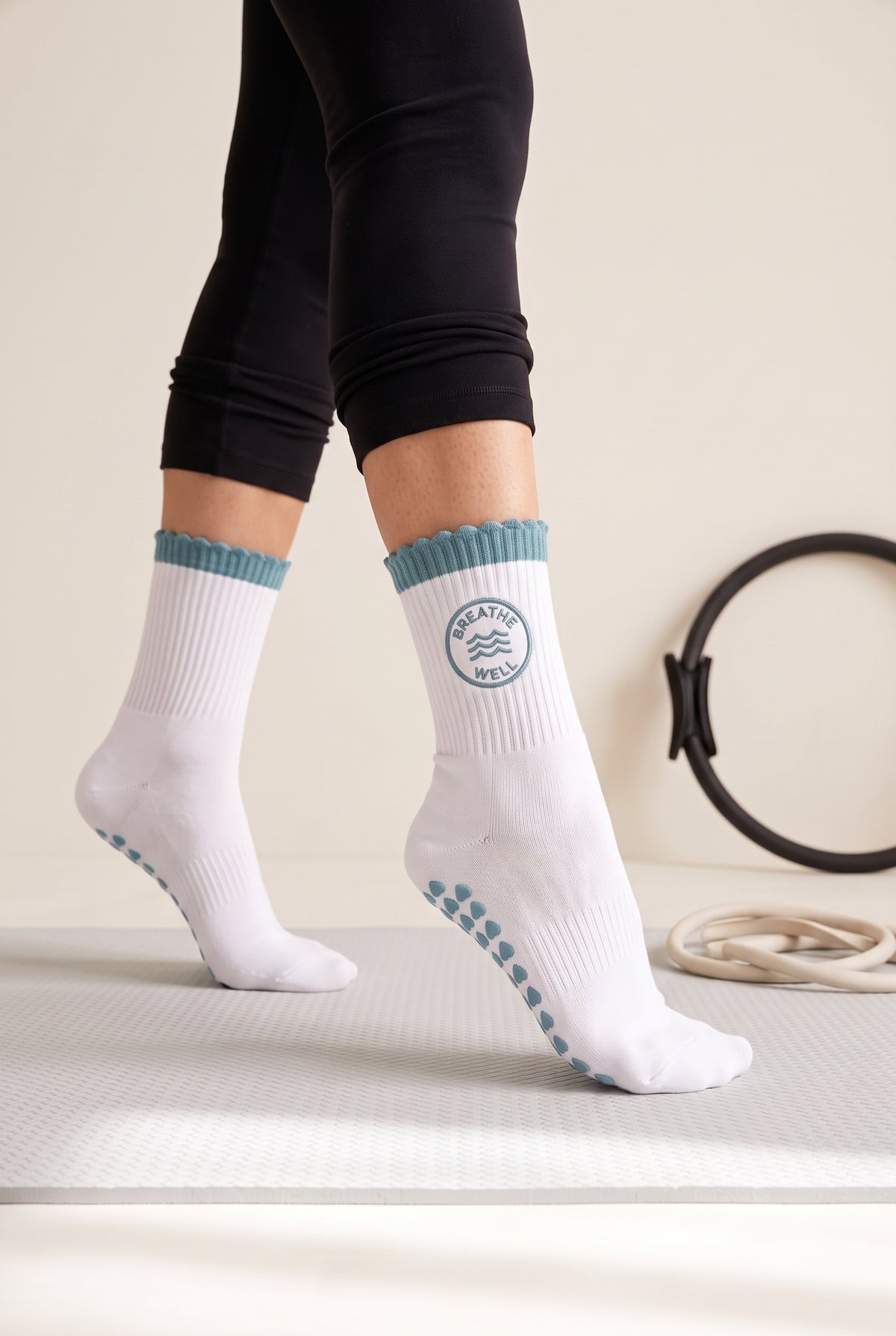 Turquoise ruffle pilates grip socks, worn in a pilates studio — embroidered to order
