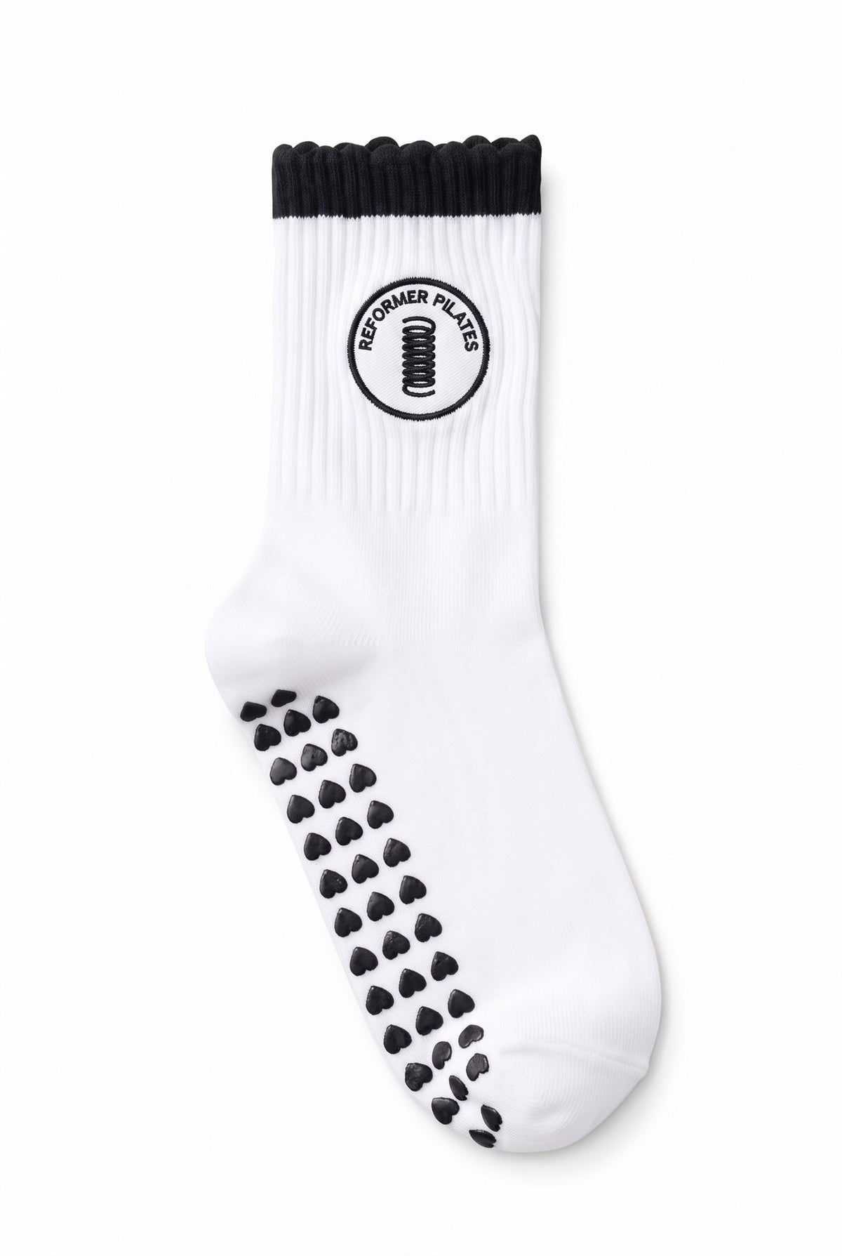 Black ruffle pilates grip socks, close-up of the custom embroidery on the ankle — embroidered to order
