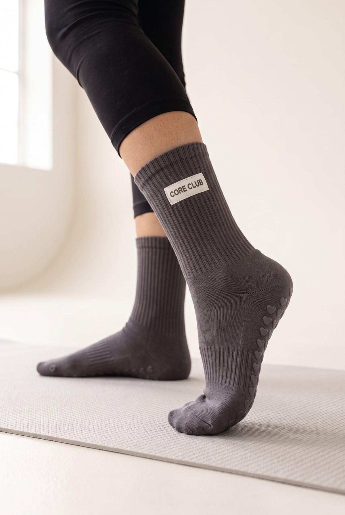 Charcoal pilates grip socks, worn, seen from the heel — embroidered to order
