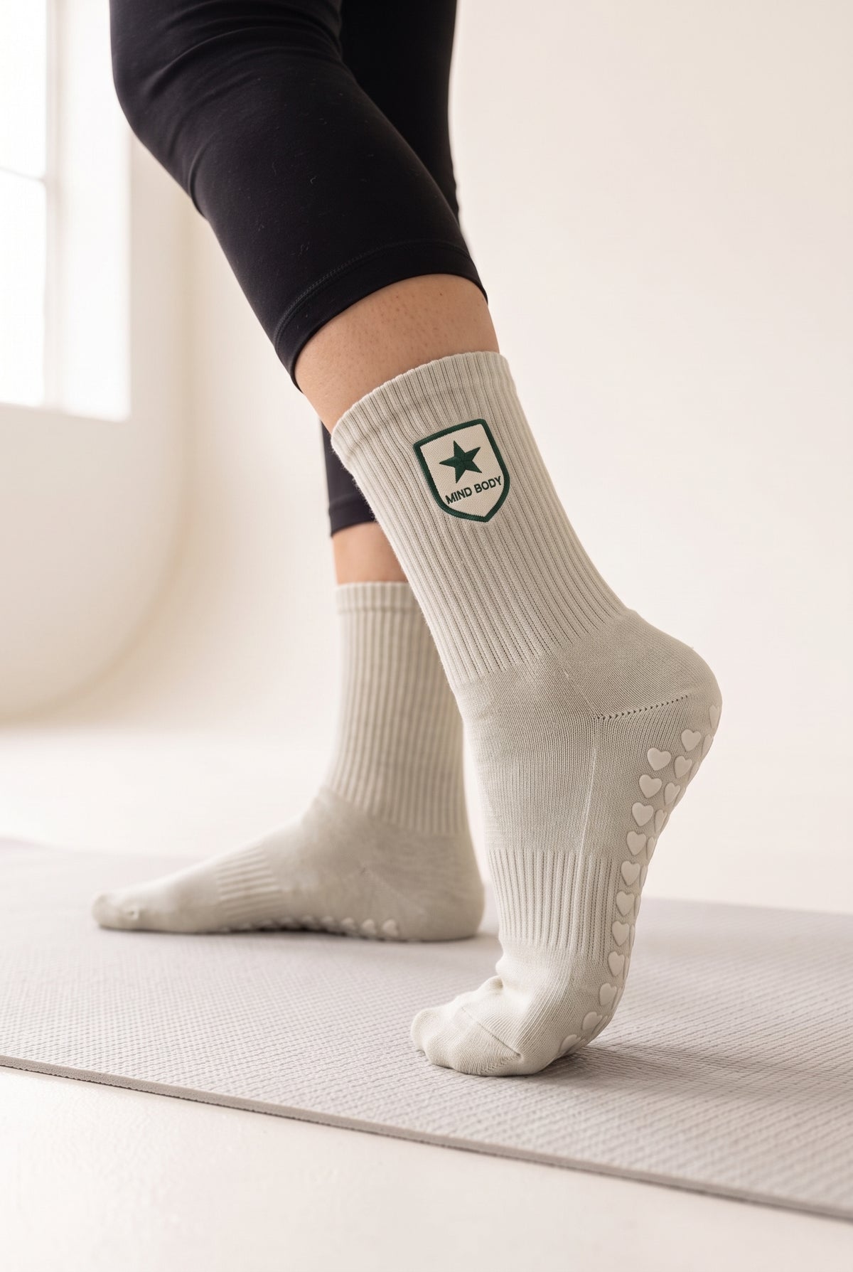 Khaki pilates grip socks, worn, seen from the heel — embroidered to order