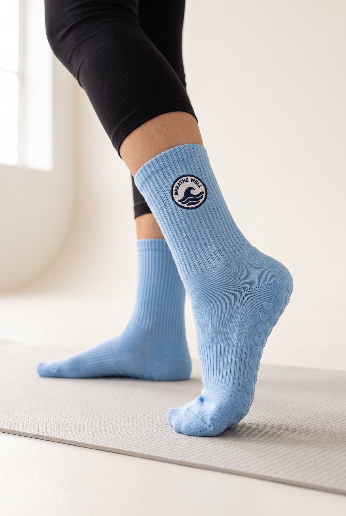 Blue pilates grip socks, worn, seen from the heel — embroidered to order
