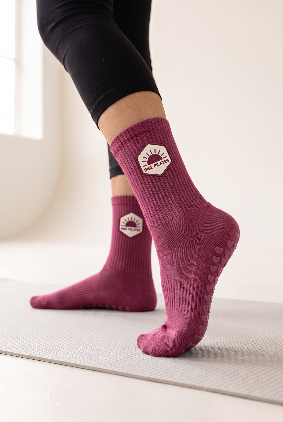 Burgundy pilates grip socks, worn, seen from the heel — embroidered to order