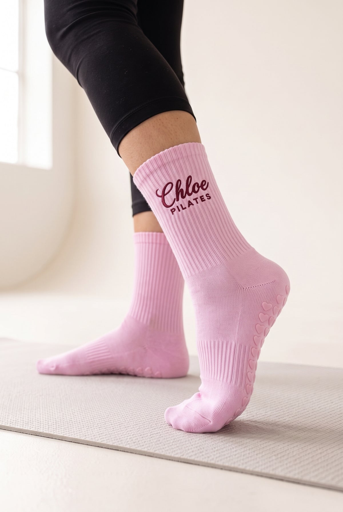 Pink pilates grip socks, worn, seen from the heel — embroidered to order