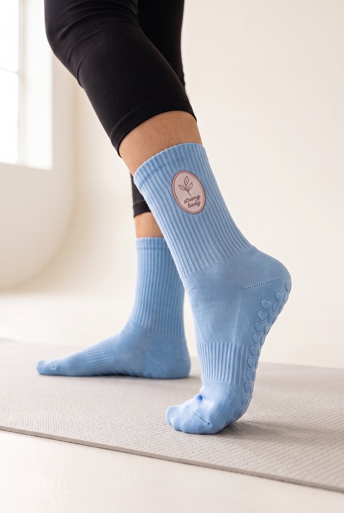 Optical White pilates grip socks, worn, seen from the heel — embroidered to order