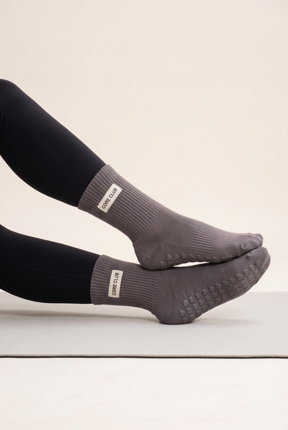 Charcoal pilates grip socks, worn, side view — embroidered to order