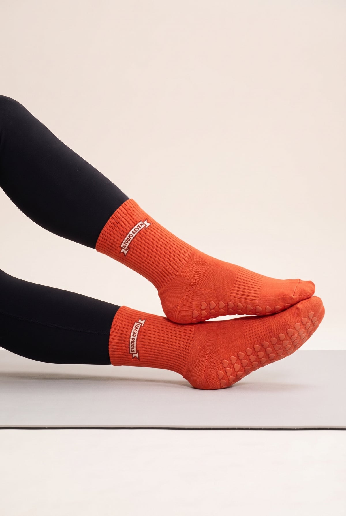 Orange pilates grip socks, worn, side view — embroidered to order