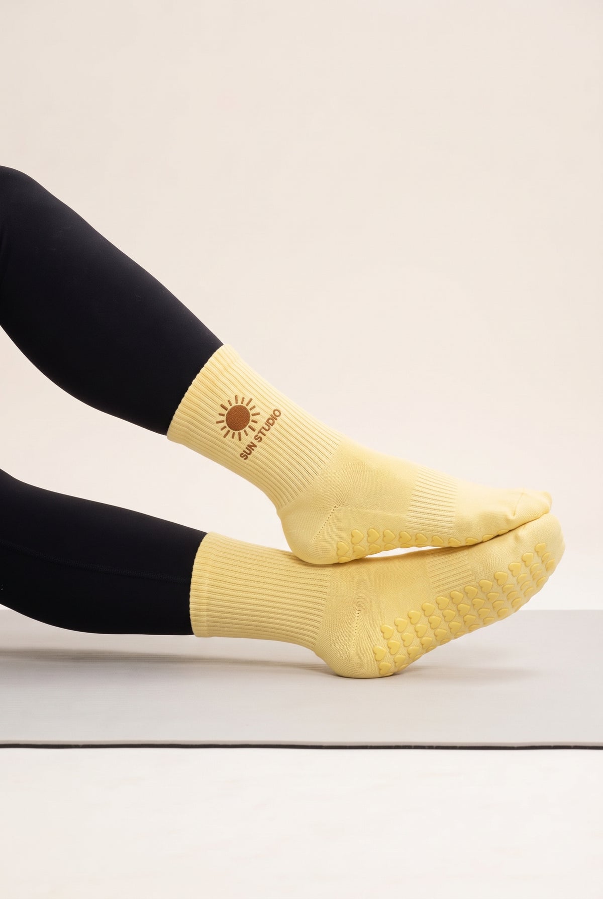 Yellow pilates grip socks, worn, side view — embroidered to order