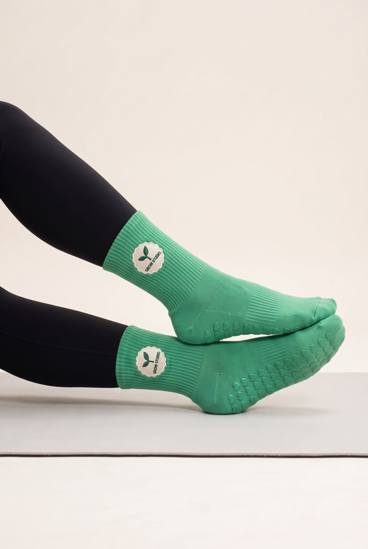 Green pilates grip socks, worn, side view — embroidered to order