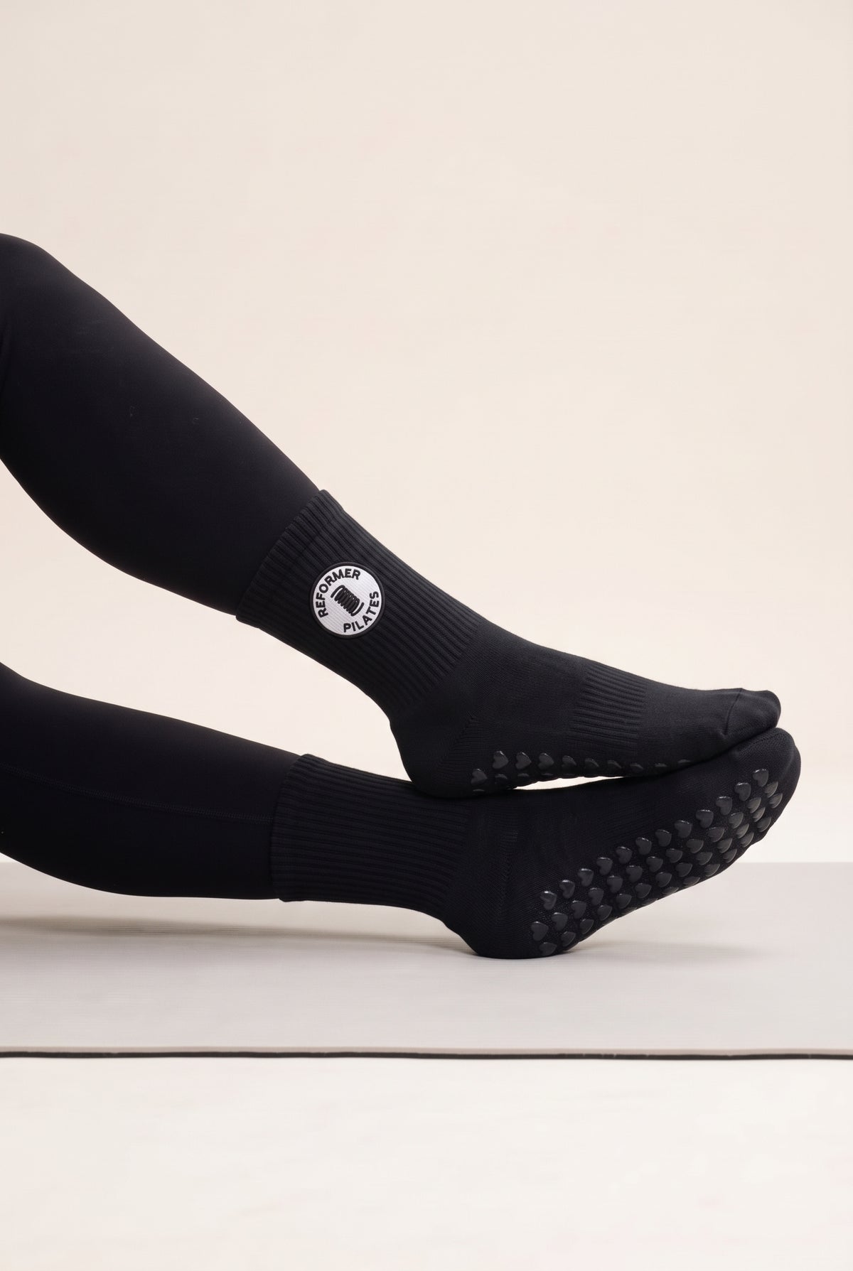 Black pilates grip socks, worn, side view — embroidered to order
